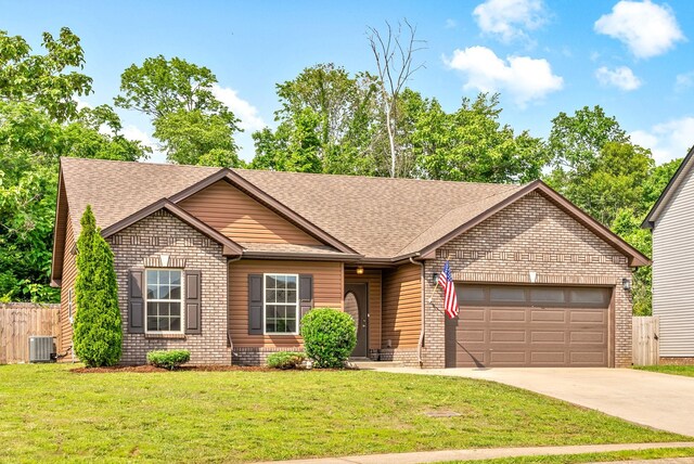1021 Charles Thomas Dr, Clarksville, TN 37042 - view of front of property featuring central AC unit, a garage, roof with shingles, brick siding, and driveway