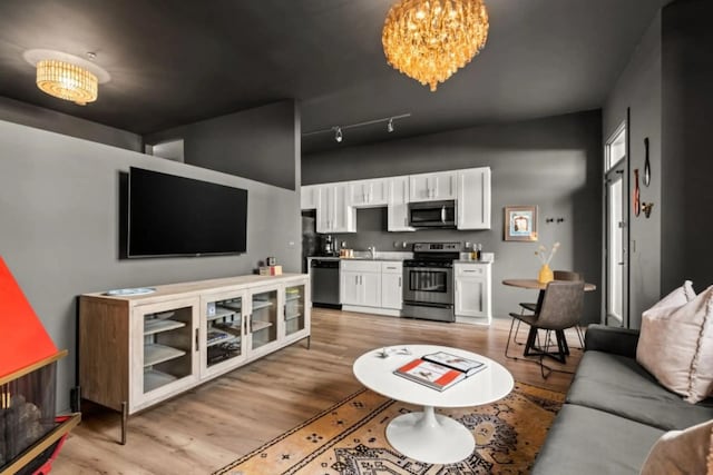 1700 Belcourt Ave Unit 103, Nashville, TN 37212 - living area featuring light wood-type flooring and a chandelier