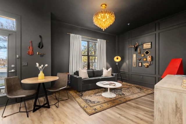 1700 Belcourt Ave Unit 103, Nashville, TN 37212 - living room with wood finished floors, a chandelier, and a decorative wall