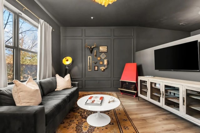 1700 Belcourt Ave Unit 103, Nashville, TN 37212 - living area featuring wood finished floors, lofted ceiling, and a decorative wall