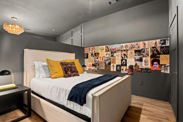 1700 Belcourt Ave Unit 103, Nashville, TN 37212 - bedroom with light wood-type flooring and a chandelier