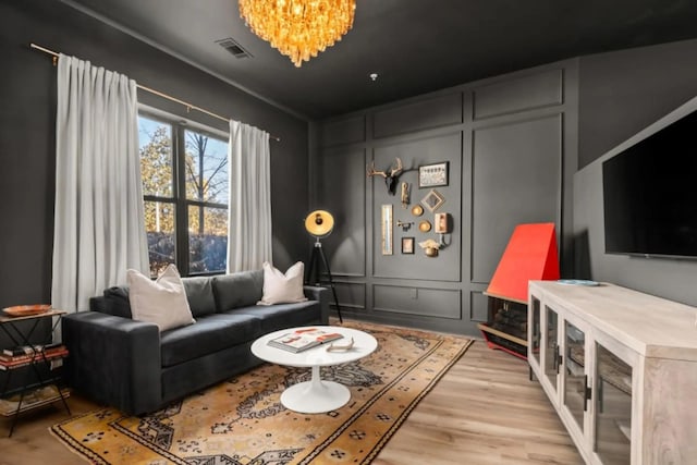 1700 Belcourt Ave Unit 103, Nashville, TN 37212 - living area featuring a decorative wall, a chandelier, and light wood-style flooring