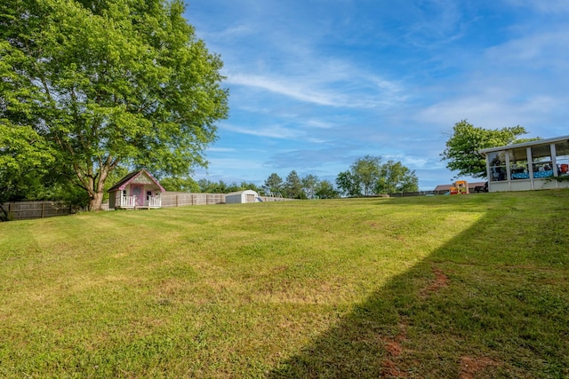 2659 Cave Springs Rd, Springfield, TN 37172 - view of yard with a storage unit, an outbuilding, and a sunroom