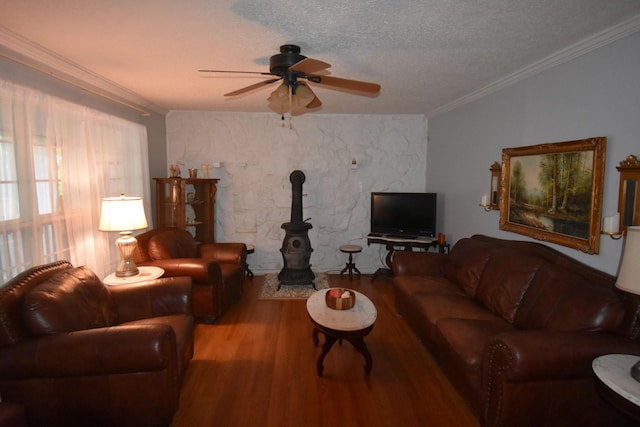 131 Scott Rd, Harriman, TN 37748 - living room with wood finished floors, a wood stove, a ceiling fan, crown molding, and a textured ceiling