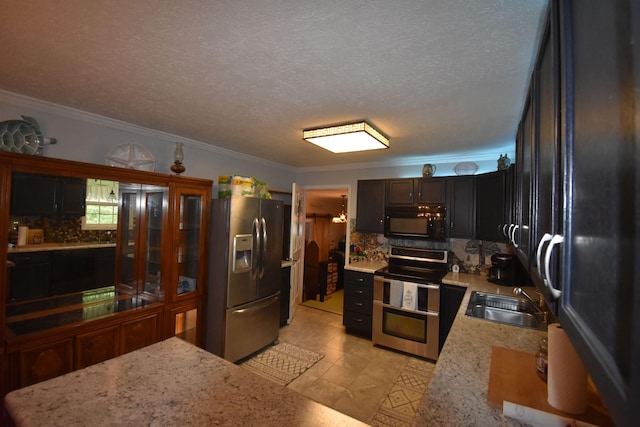 131 Scott Rd, Harriman, TN 37748 - kitchen featuring stainless steel appliances, a sink, backsplash, ornamental molding, and light stone countertops