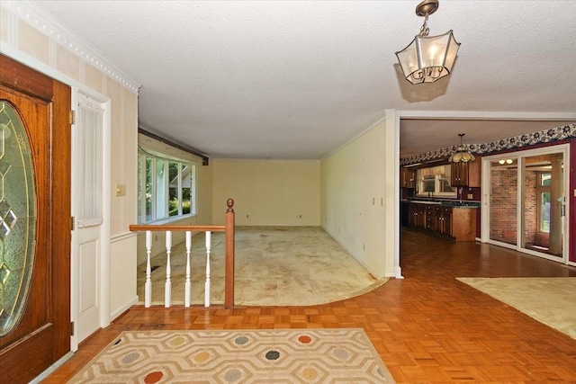 103 Colwell Ln, Manchester, TN 37355 - foyer featuring ornamental molding, a chandelier, a textured ceiling, and baseboards
