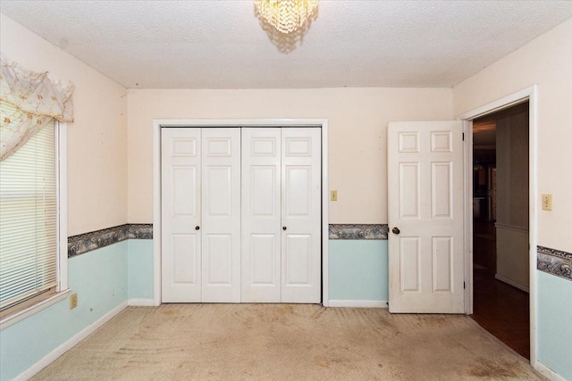 103 Colwell Ln, Manchester, TN 37355 - unfurnished bedroom featuring light colored carpet, a closet, baseboards, and a textured ceiling