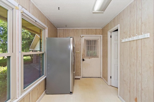 103 Colwell Ln, Manchester, TN 37355 - kitchen with freestanding refrigerator, wood walls, light floors, a textured ceiling, and crown molding