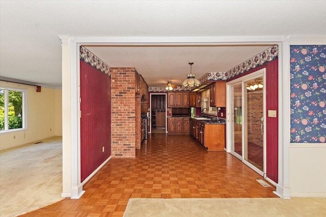 103 Colwell Ln, Manchester, TN 37355 - kitchen with a sink, baseboards, dark countertops, a textured ceiling, and ornamental molding