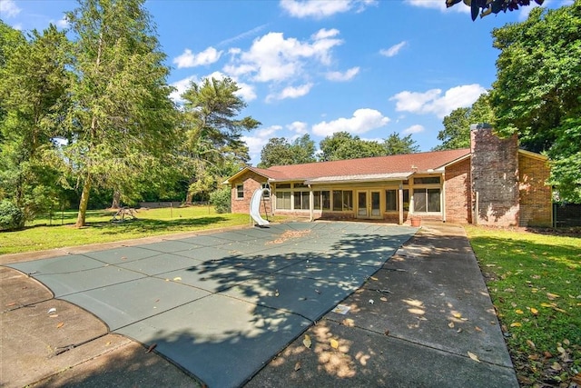 103 Colwell Ln, Manchester, TN 37355 - view of front of home with brick siding, a chimney, a covered pool, and a patio area