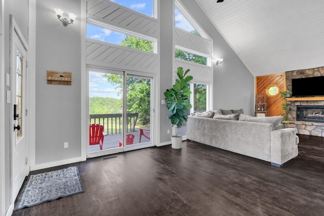 462 Clifford Dykes Rd, Tracy City, TN 37387 - living room with high vaulted ceiling, a fireplace, wooden walls, wood finished floors, and baseboards