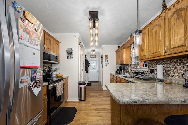 155 Deer Cir, Estill Springs, TN 37330 - kitchen featuring appliances with stainless steel finishes, light wood-style flooring, brown cabinetry, decorative backsplash, and crown molding