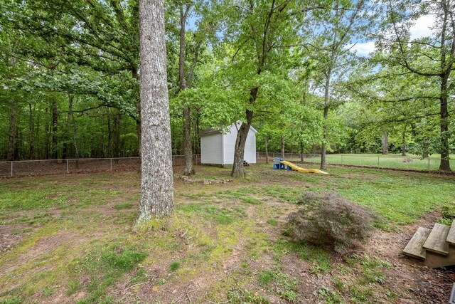 155 Deer Cir, Estill Springs, TN 37330 - fenced backyard featuring a storage unit and an outbuilding