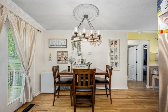 155 Deer Cir, Estill Springs, TN 37330 - dining area featuring a chandelier, light wood-style flooring, ornamental molding, healthy amount of natural light, and baseboards