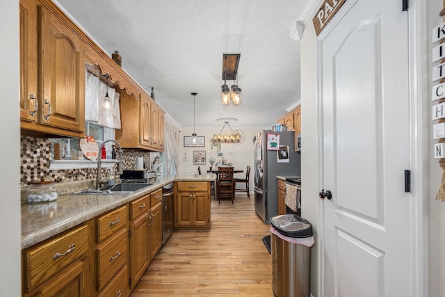 155 Deer Cir, Estill Springs, TN 37330 - kitchen with a sink, appliances with stainless steel finishes, light wood-style floors, and brown cabinets
