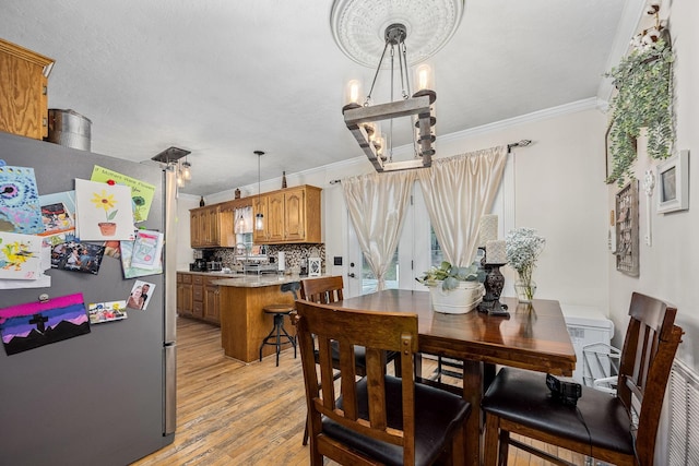 155 Deer Cir, Estill Springs, TN 37330 - dining area featuring a chandelier, crown molding, and light wood-style floors