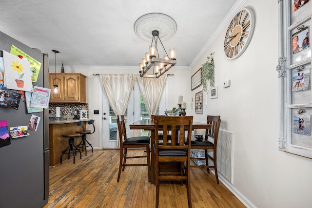 155 Deer Cir, Estill Springs, TN 37330 - dining area featuring hardwood / wood-style flooring, a chandelier, crown molding, and baseboards