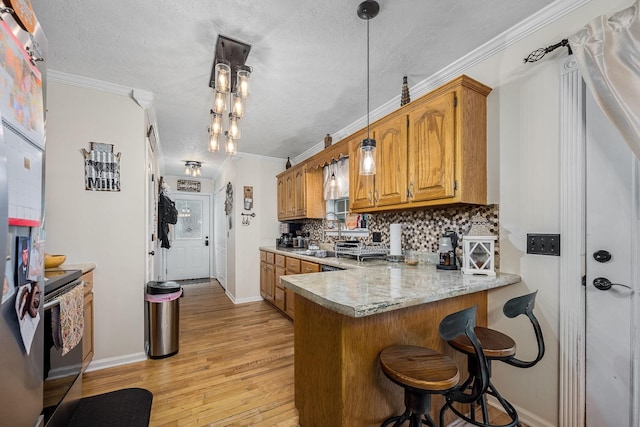 155 Deer Cir, Estill Springs, TN 37330 - kitchen featuring range with electric stovetop, light countertops, light wood-style floors, tasteful backsplash, and brown cabinetry