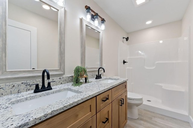 7803 Monterey Hwy, Sparta, TN 38583 - bathroom featuring toilet, a shower, wood finished floors, and double vanity