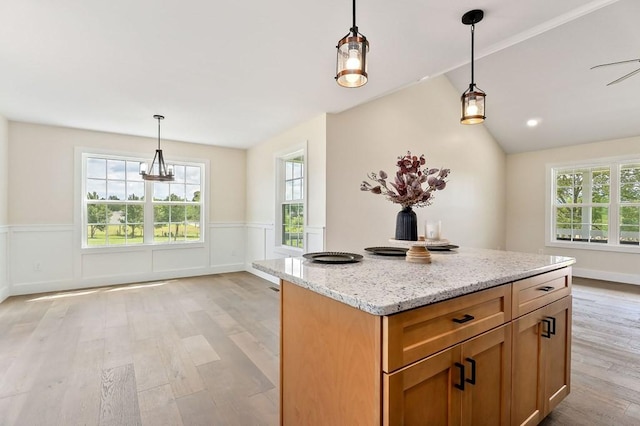 7803 Monterey Hwy, Sparta, TN 38583 - kitchen featuring light wood-type flooring, plenty of natural light, a wainscoted wall, light stone countertops, and pendant lighting