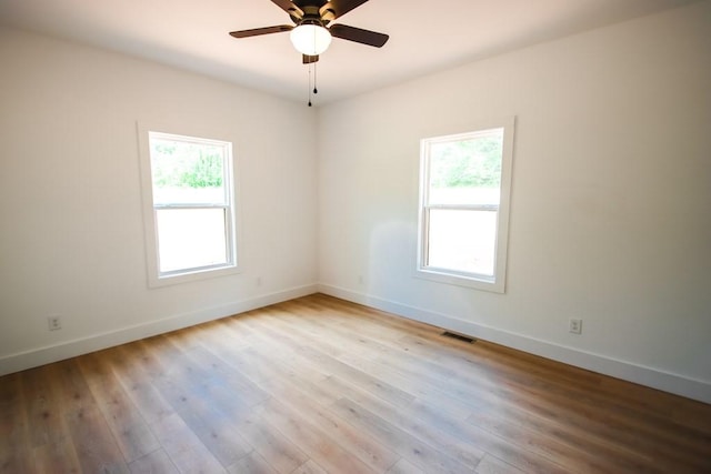 70 River Oaks Dr, Sparta, TN 38583 - unfurnished room with healthy amount of natural light, baseboards, ceiling fan, and wood finished floors