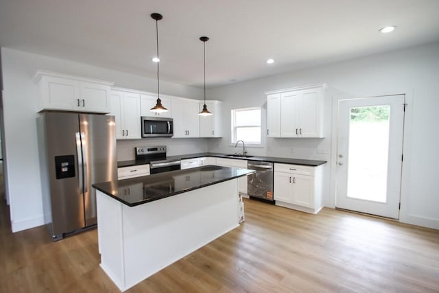 70 River Oaks Dr, Sparta, TN 38583 - kitchen featuring appliances with stainless steel finishes, a sink, light wood finished floors, white cabinets, and dark countertops
