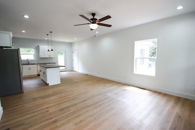 70 River Oaks Dr, Sparta, TN 38583 - kitchen featuring freestanding refrigerator, dark countertops, open floor plan, ceiling fan, and a sink