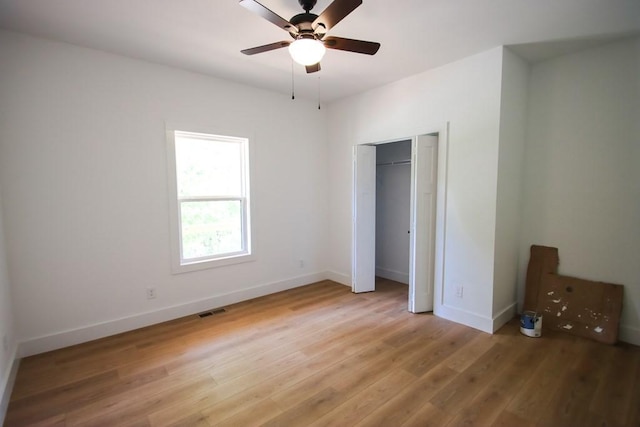 70 River Oaks Dr, Sparta, TN 38583 - unfurnished bedroom with light wood-style flooring, baseboards, a ceiling fan, and a closet