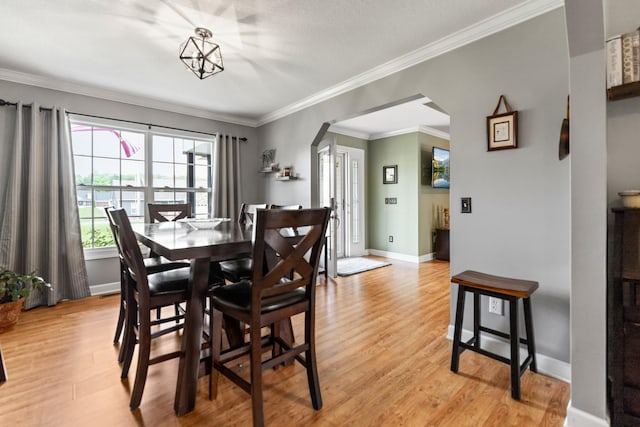 1383 Smith Chapel Rd, Shelbyville, TN 37160 - dining area featuring arched walkways, light wood-type flooring, ornamental molding, and baseboards