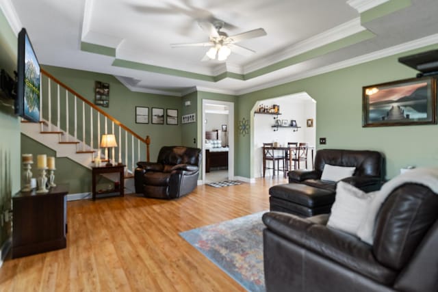 1383 Smith Chapel Rd, Shelbyville, TN 37160 - living room featuring a raised ceiling, ceiling fan, wood finished floors, stairway, and ornamental molding