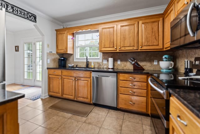 1383 Smith Chapel Rd, Shelbyville, TN 37160 - kitchen with appliances with stainless steel finishes, a sink, crown molding, brown cabinetry, and dark countertops