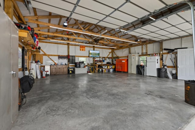 1383 Smith Chapel Rd, Shelbyville, TN 37160 - garage featuring freestanding refrigerator and a workshop area