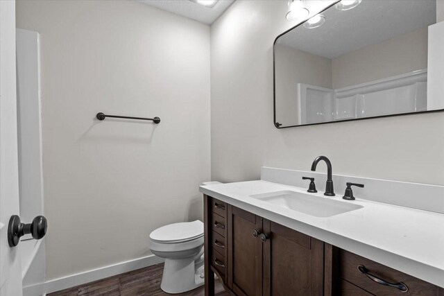 1079 Hillcrest Rd, Waverly, TN 37185 - bathroom featuring wood finished floors, toilet, vanity, and baseboards