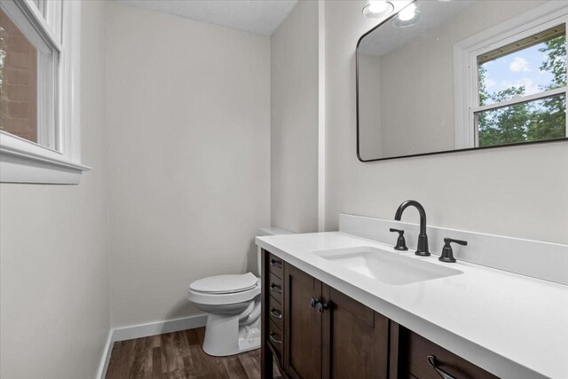 1079 Hillcrest Rd, Waverly, TN 37185 - bathroom featuring wood finished floors, toilet, vanity, and baseboards