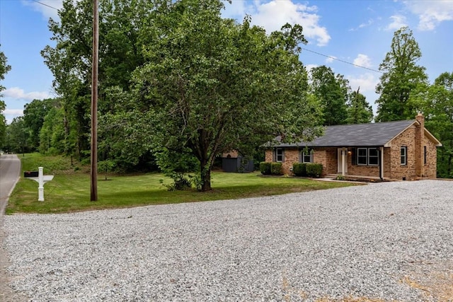 1079 Hillcrest Rd, Waverly, TN 37185 - ranch-style home featuring gravel driveway, a front lawn, a chimney, and brick siding