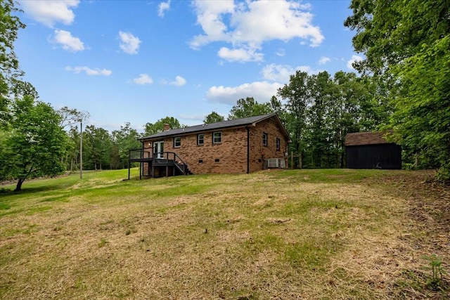 1079 Hillcrest Rd, Waverly, TN 37185 - back of house featuring stairs, a wooden deck, a lawn, central air condition unit, and an outbuilding