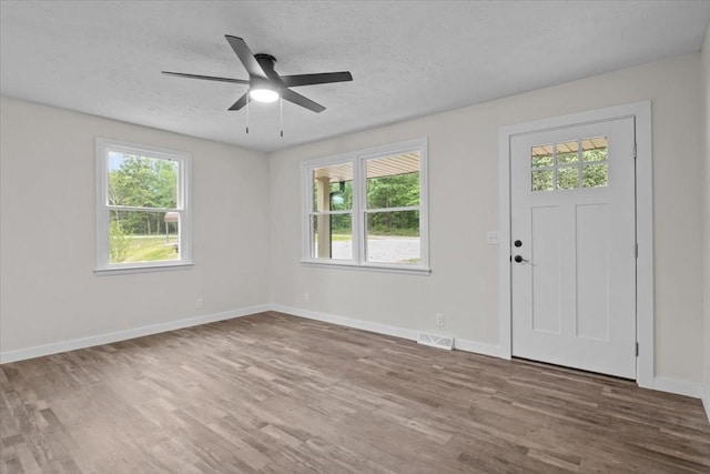 1079 Hillcrest Rd, Waverly, TN 37185 - entrance foyer featuring healthy amount of natural light, wood finished floors, baseboards, and a textured ceiling