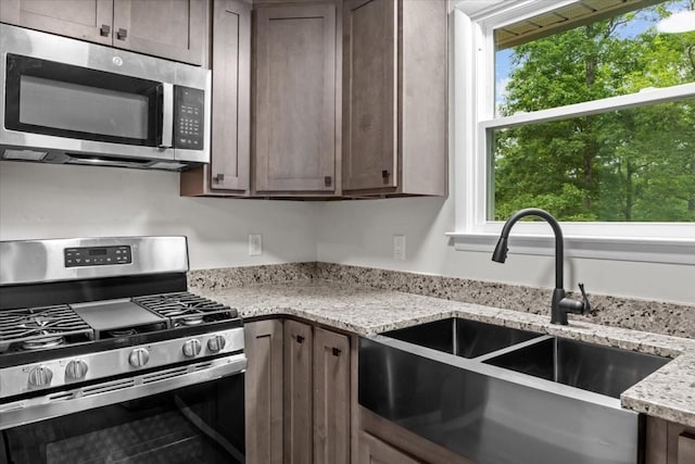 1079 Hillcrest Rd, Waverly, TN 37185 - kitchen featuring stainless steel appliances, a sink, healthy amount of natural light, and light stone counters