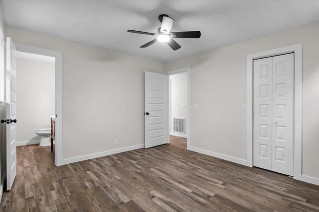1079 Hillcrest Rd, Waverly, TN 37185 - unfurnished bedroom with dark wood-type flooring, baseboards, and a closet