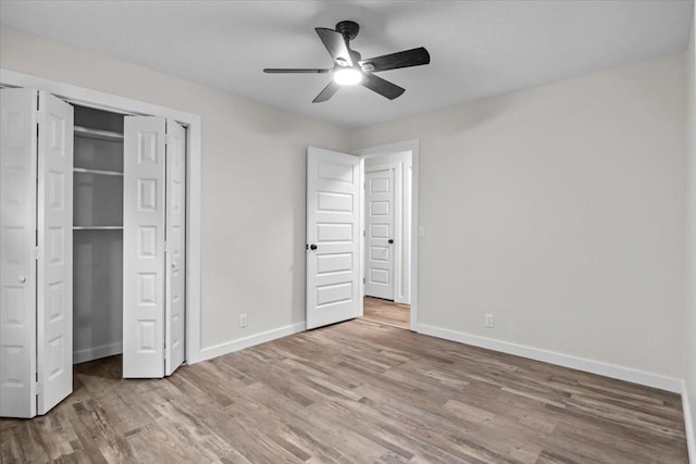 1079 Hillcrest Rd, Waverly, TN 37185 - unfurnished bedroom with wood finished floors, baseboards, a closet, and ceiling fan