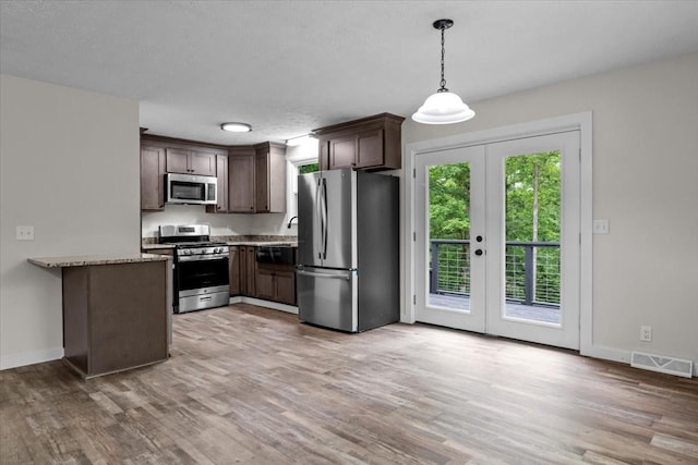 1079 Hillcrest Rd, Waverly, TN 37185 - kitchen featuring appliances with stainless steel finishes, french doors, light wood-style floors, and baseboards