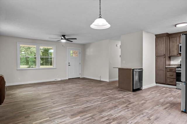 1079 Hillcrest Rd, Waverly, TN 37185 - kitchen featuring open floor plan, light wood-type flooring, a ceiling fan, baseboards, and decorative light fixtures