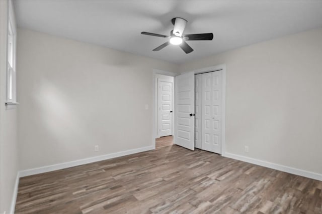 1079 Hillcrest Rd, Waverly, TN 37185 - unfurnished bedroom with wood finished floors, baseboards, a closet, and a ceiling fan