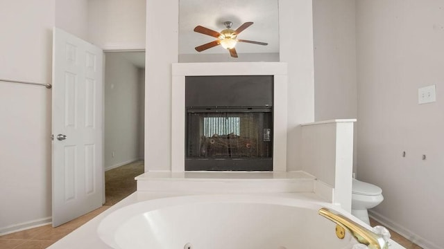 517 Eversholt Ct, Antioch, TN 37013 - bathroom with a jetted tub, ceiling fan, toilet, and a fireplace