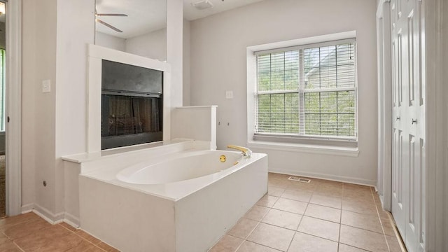 517 Eversholt Ct, Antioch, TN 37013 - full bath featuring healthy amount of natural light, tile patterned floors, a bath, and baseboards