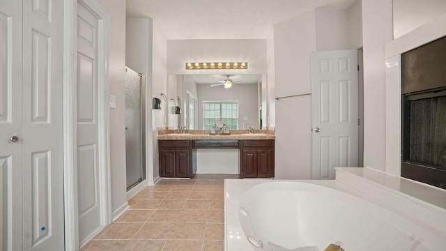 517 Eversholt Ct, Antioch, TN 37013 - full bathroom featuring a shower stall, tile patterned floors, a garden tub, a closet, and vanity