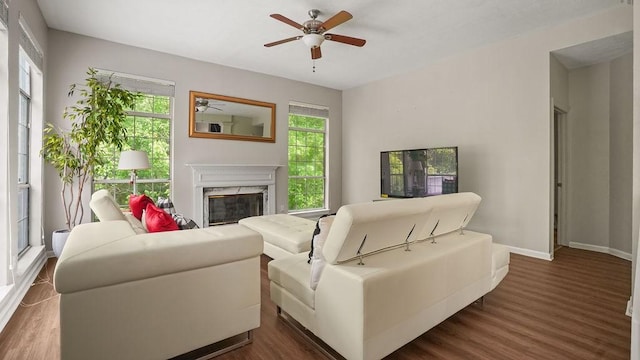 517 Eversholt Ct, Antioch, TN 37013 - living room featuring a ceiling fan, a premium fireplace, dark wood-style floors, and baseboards