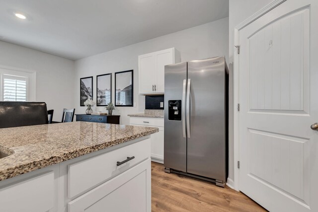 5312 Owens Ln, White House, TN 37188 - kitchen featuring stainless steel fridge with ice dispenser, light wood finished floors, white cabinetry, light stone countertops, and recessed lighting
