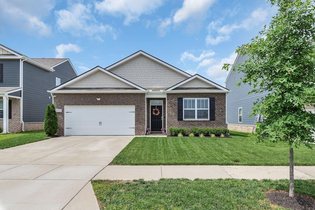 5312 Owens Ln, White House, TN 37188 - craftsman house with brick siding, concrete driveway, a front yard, and a garage