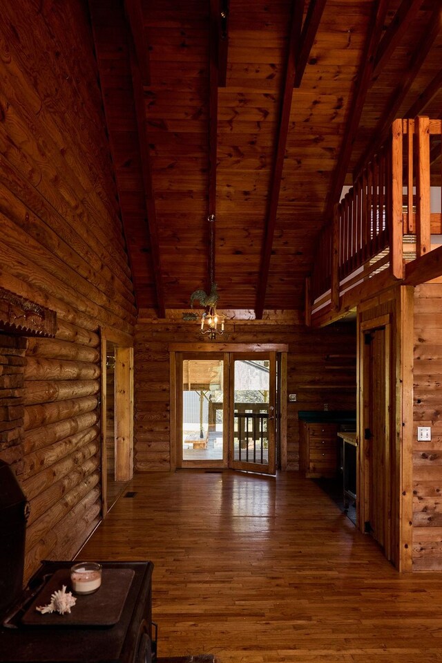 1794 Mosley Ferry Rd, Chapmansboro, TN 37035 - unfurnished living room featuring wood ceiling, hardwood / wood-style floors, a chandelier, beamed ceiling, and high vaulted ceiling